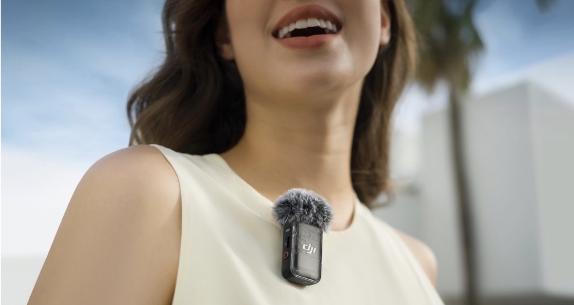 A wearable clip-on microphone capturing an in-person conversation